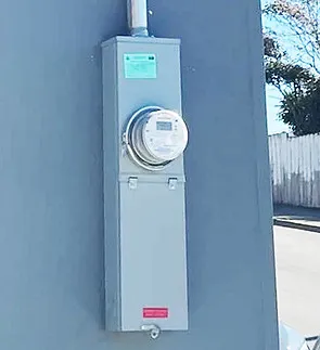 Outdoor electrical meter installed on a wall, showcasing the work of Chasov Electrical, Voice & Data in San Francisco.