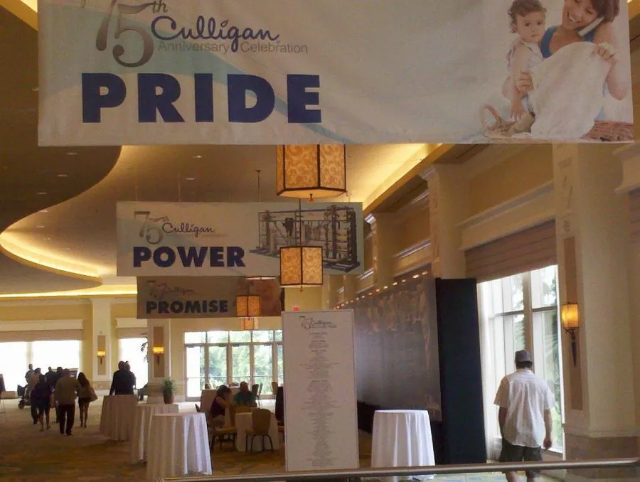 Indoor celebration for Culligan Water's 75th anniversary with banners reading "PRIDE," "POWER," and "PROMISE" in a decorated hallway setting in Santa Rosa.