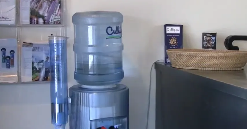 Culligan Water dispenser in an office setting with brochures and a basket on the counter, providing hydration in Santa Rosa.