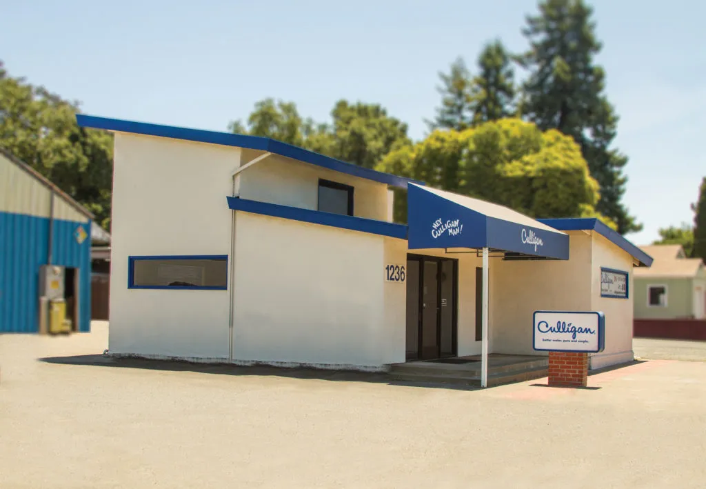 A photo of the Culligan Water of Sonoma County building in Santa Rosa, featuring a white structure with blue accents and a prominent Culligan sign in front.