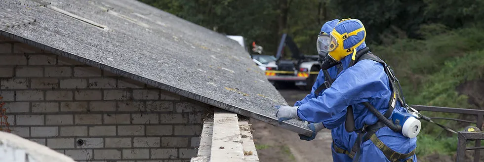 Worker in protective gear removing asbestos in Petaluma under the services of Curran Environmental Services Inc.