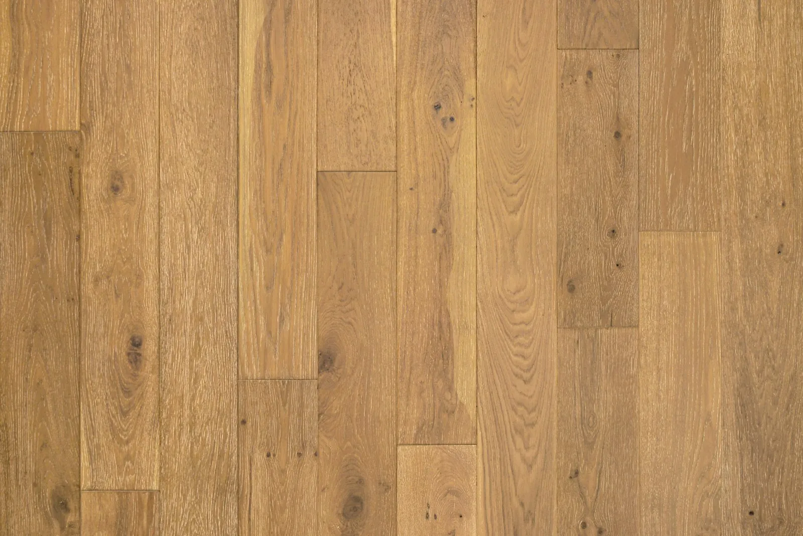 Close-up of a wooden floor with light brown oak planks, showcasing the craftsmanship of the Danville Hardwood Company in Danville.
