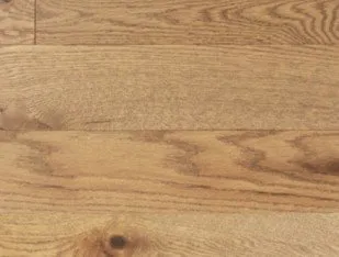 Close-up image of a polished hardwood floor featuring natural wood grain patterns, offered by Danville Hardwood Company in Danville.