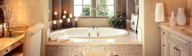 A luxurious bathroom with a central bathtub surrounded by candles and decor elements, designed by David Bianchi Home Repair, Inc. in Vacaville.