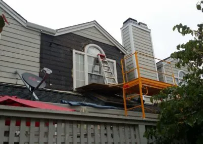 "A house under renovation with scaffolding and construction materials, managed by DiazandSonsConstruction in SantaRosa."