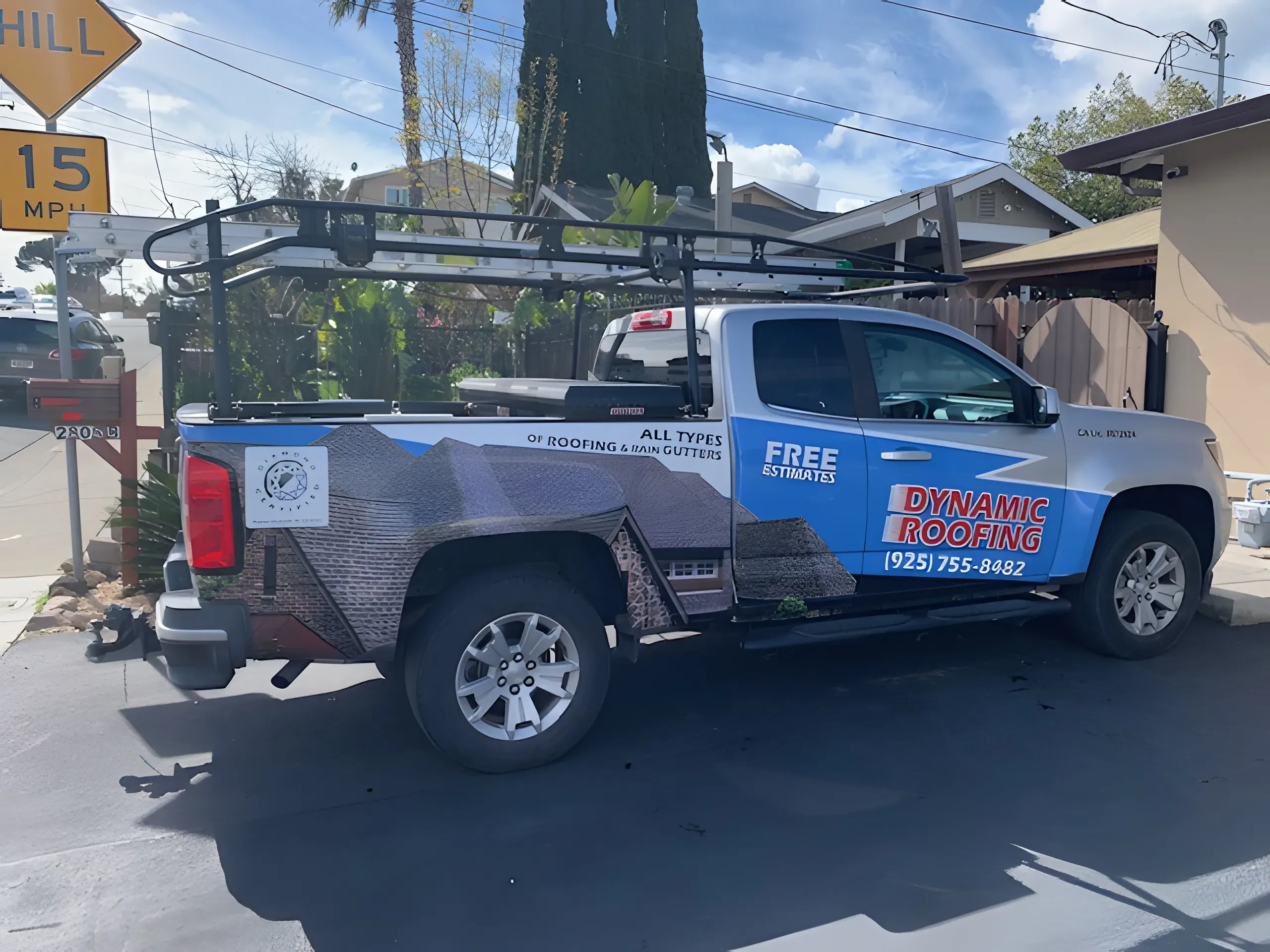 A Dynamic Roofing Inc. truck with company branding parked on a residential street in Antioch, featuring equipment for roofing services.