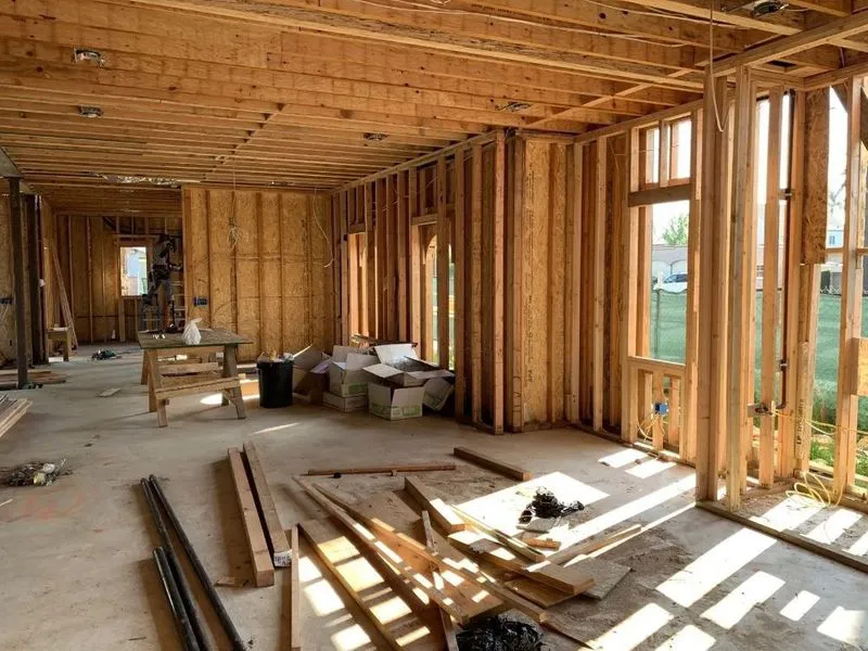 Interior view of a construction site with wooden framing and various building materials at an Edri Construction project in Walnut Creek.