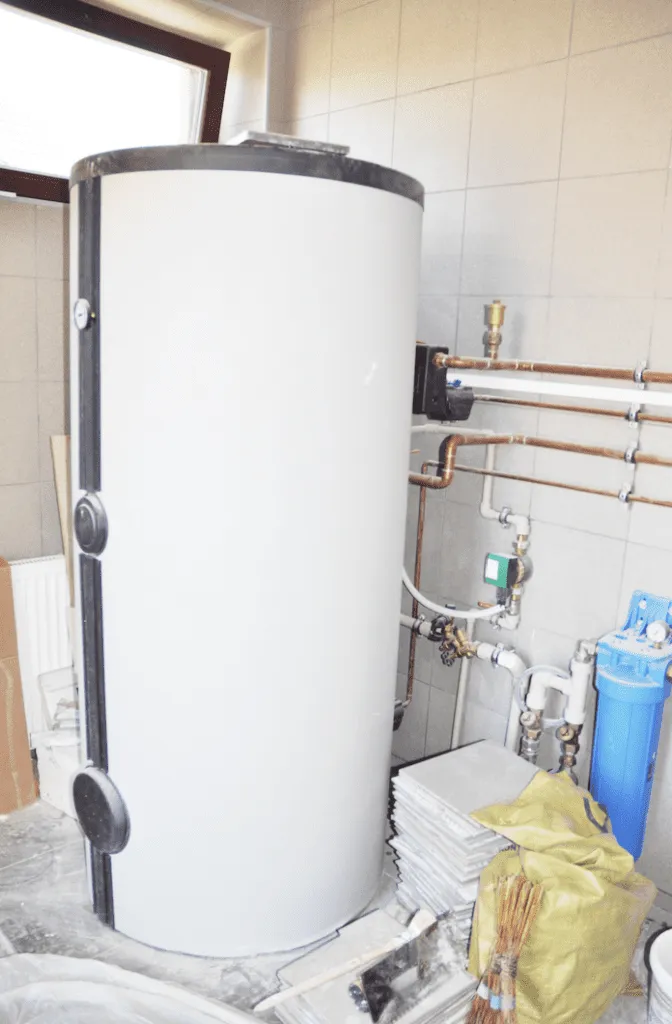A water heater installation in progress with pipes and fittings visible, showcasing the craftsmanship of ElitePlumbingServices in Cotati.