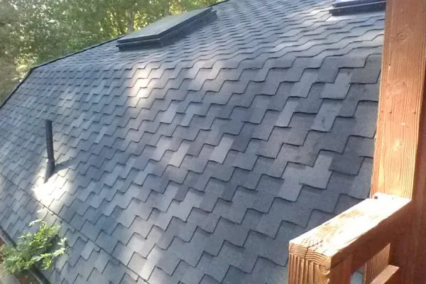 A rooftop with dark shingles, showcasing the quality craftsmanship of FalconRoofing in San Jose.