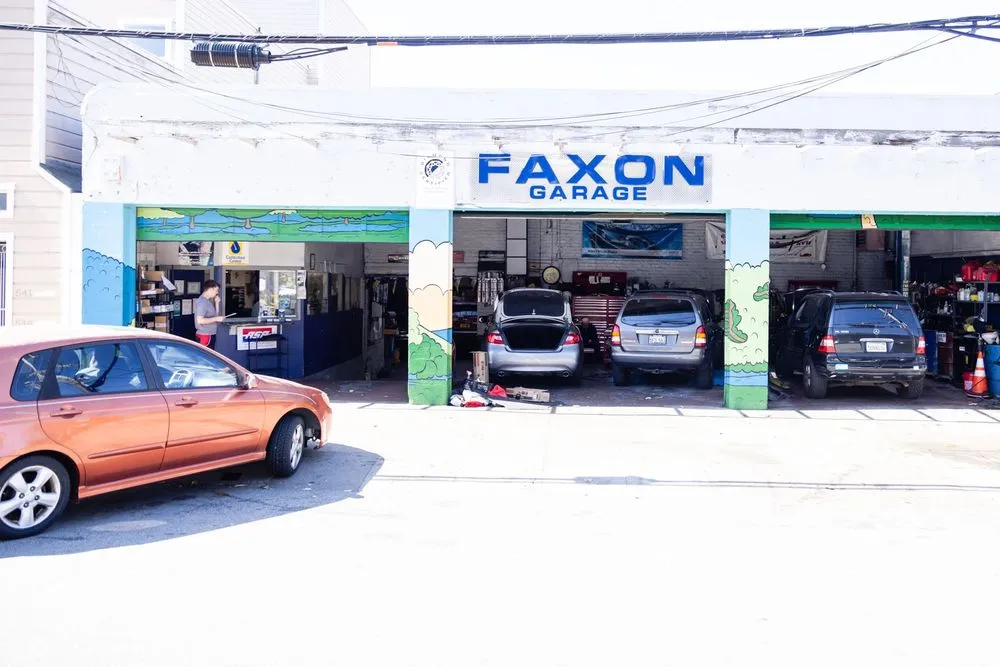 Exterior view of Faxon Garage in San Francisco, featuring three vehicles parked in open service bays.