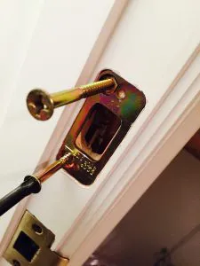 "Close-up of a door lock being installed with a screwdriver, emphasizing security and precision by First Lock & Security Technologies in Los Altos."