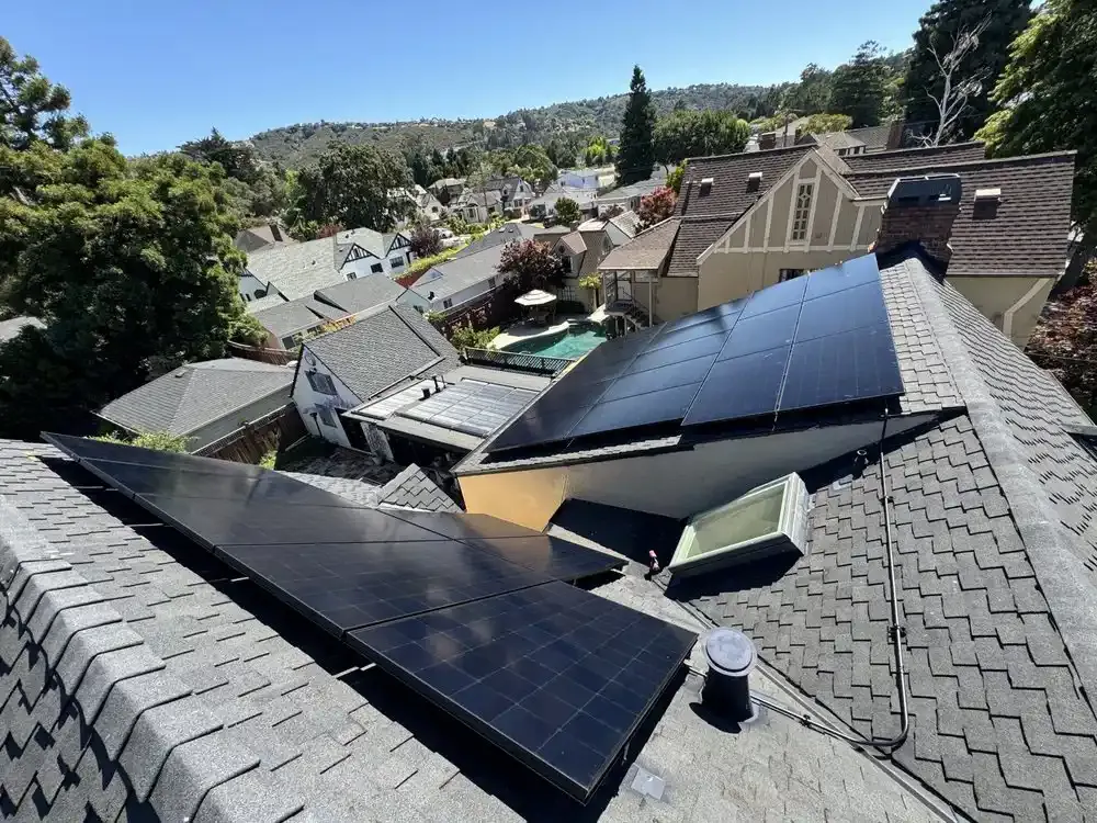 Rooftop solar panels installed on houses in Campbell by Freedom Solar, Inc., showcasing a residential neighborhood surrounded by trees and hills.