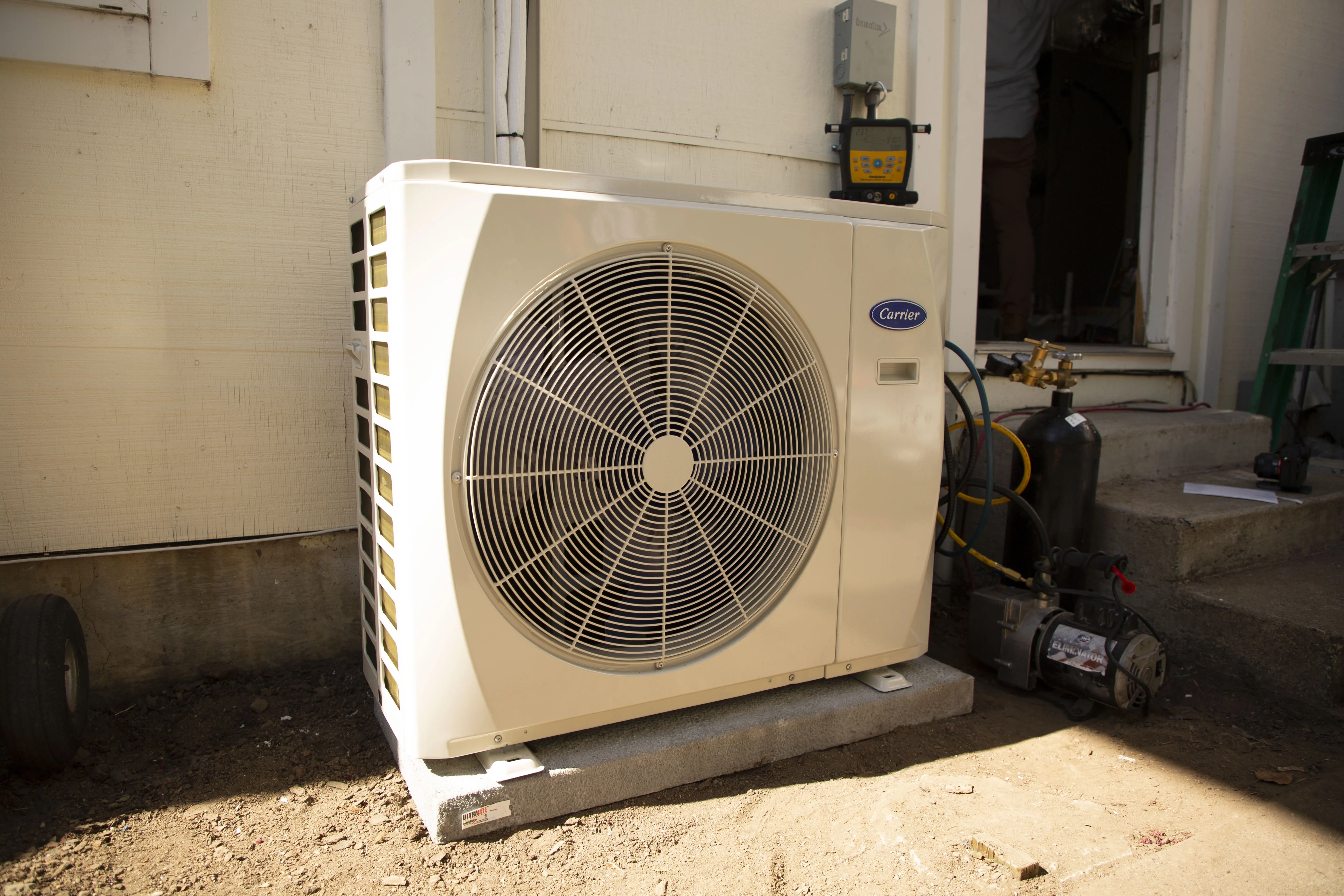 An air conditioning unit installed outside a building, showcasing its robust design and modern features.