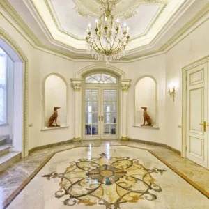 Ornate hallway with a chandelier and intricate floor design, showcasing Heavenly Touch's architectural elegance in San Jose.