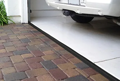 A car parked in a garage with a rubber seal at the entrance, provided by Help Garage Door in Sacramento.