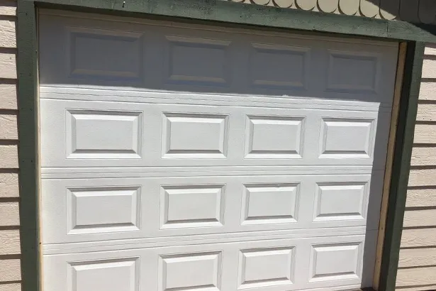A white garage door on a residential building, showcasing the quality work of Help Garage Door in Sacramento.
