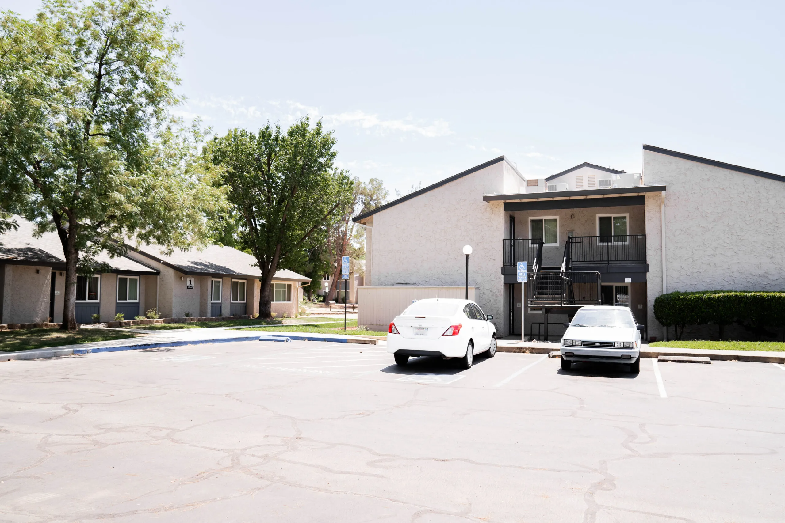 Image of a residential complex in Sacramento with paved parking spaces, showcasing the architectural work of Heritage Exteriors Inc.