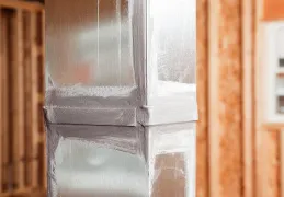 Close-up of a metal HVAC duct in a construction setting, installed by Hometown Heating & Air Conditioning in Concord.