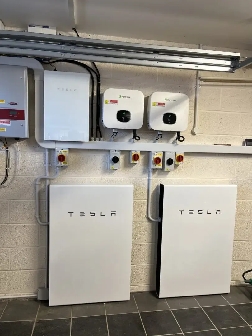A wall-mounted setup featuring Tesla and Growatt smart energy systems installed by Integrity Electric, Inc. in San Rafael.