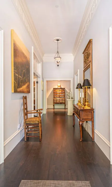 A well-designed hallway featuring classic furniture, decorative lighting, and artworks, showcasing the renovation work by Intentional Contracting Inc. in Santa Rosa.