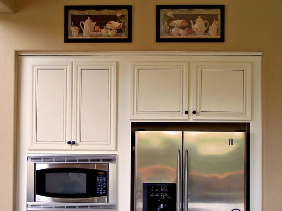 Elegant kitchen design featuring white cabinetry, a stainless steel refrigerator, and a built-in microwave, completed by Irwin Construction Kitchen and Bath in Gilroy.