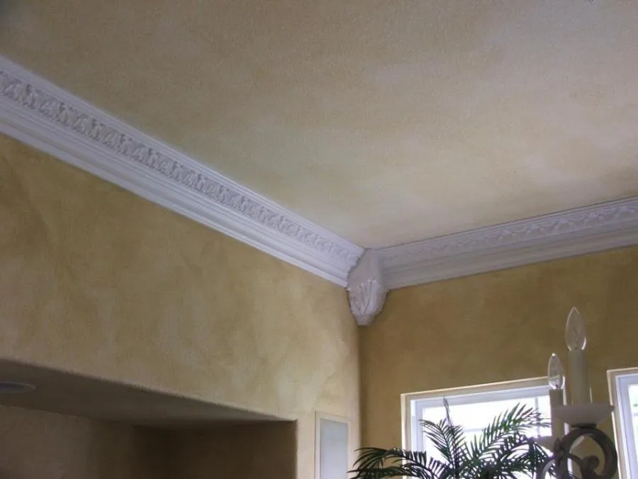 Image of a room corner with intricate white crown molding, highlighting detailed architectural design, installed by Irwin Construction Kitchen and Bath in Gilroy.