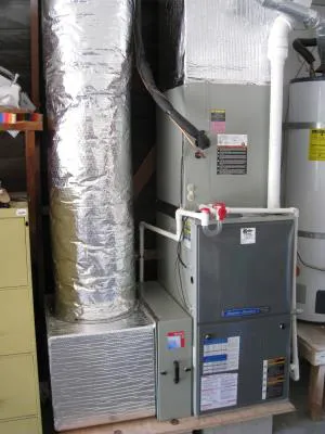 Image of a residential heating unit installed by Kelly Plumbing & Heating, Inc. in Novato, showing ductwork and a furnace system.