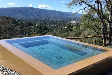 An elevated rectangular pool with a clear view of a mountainous landscape in the background, showcasing an elegant design by Koch & Associates, Inc. in Fremont.
