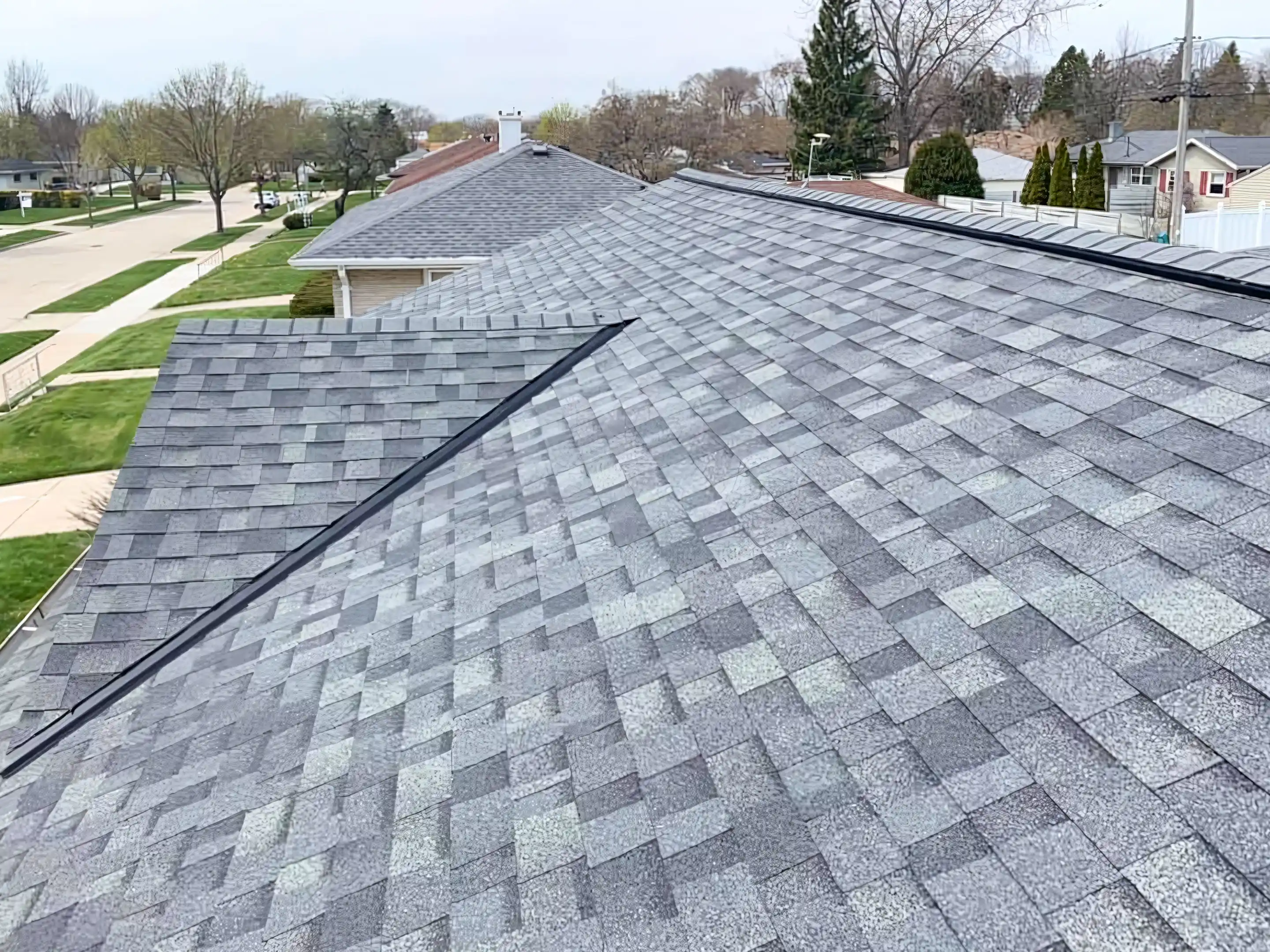 A newly installed shingle roof by LJ Contractors in Franklin, featuring a seamless and uniform pattern.