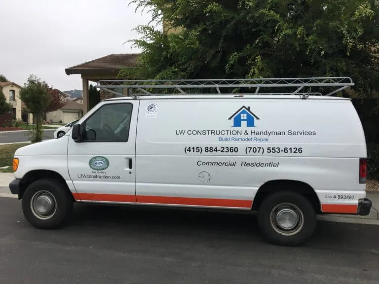 A white van for LW Construction & Handyman Services, featuring company logo and contact information, parked in a residential area of American Canyon.