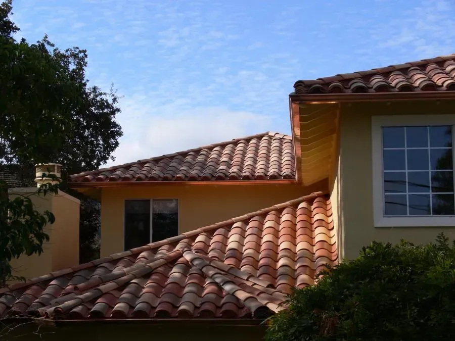 A well-designed clay tile roof on a residential home, completed by Los Gatos Roofing in San Jose, set against a blue sky.