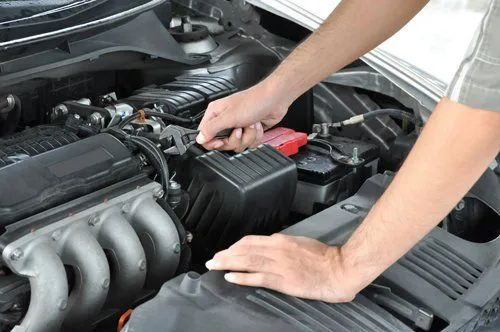 A mechanic using a wrench to work on a car engine at MSI Automotive in San Rafael.
