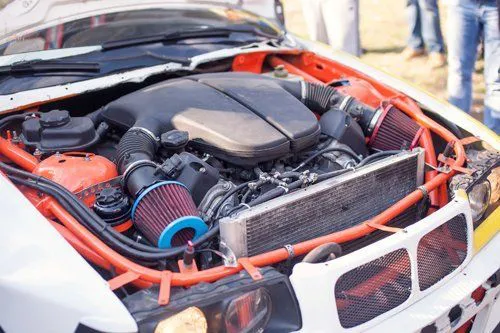Close-up of a car engine featuring modified components and performance enhancements by MSI Automotive, located in San Rafael.