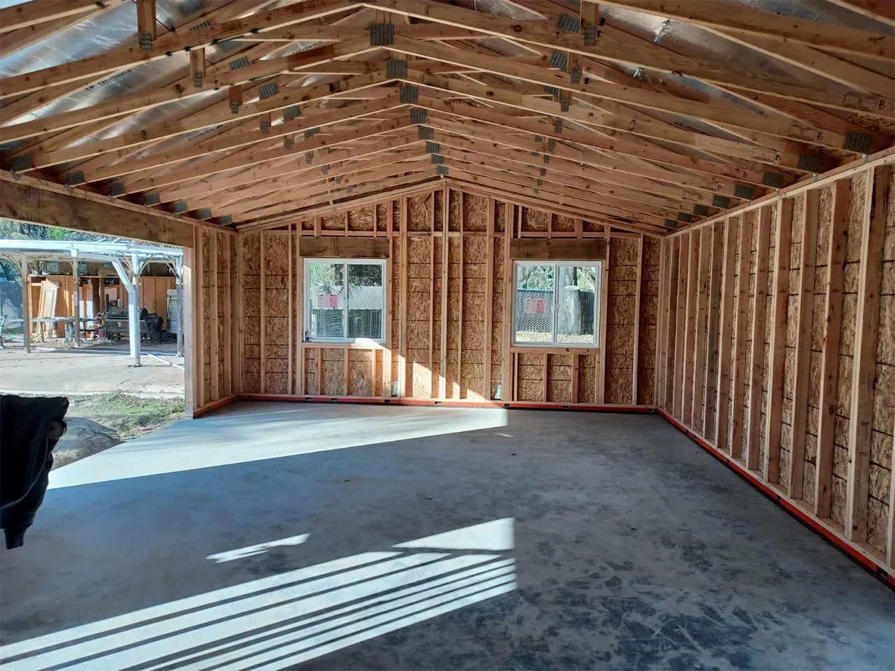 Interior view of a partially constructed building with wooden framing and concrete floor, showcasing construction work by Mana Construction Inc. in Vallejo.