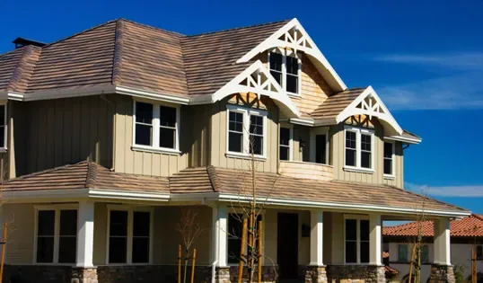 A large house with a newly installed roof in Fremont, showcasing the craftsmanship of Marco Roofing.