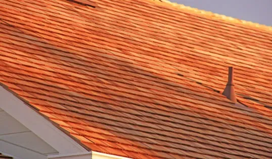 A close-up view of a well-installed shingle roof with a vent pipe, showcasing Marco Roofing's quality work in Fremont.