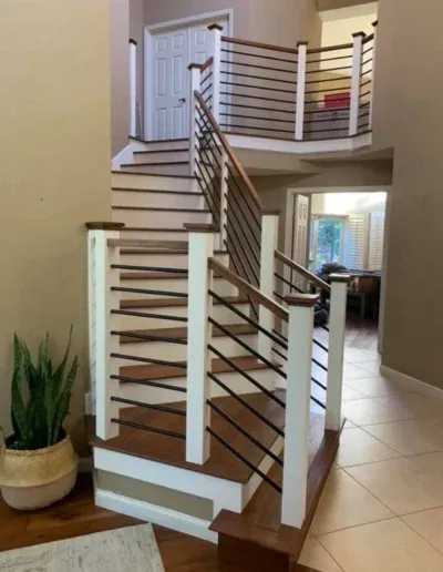 A modern staircase with wooden steps and metal railings, designed by Martinez Stair Co. in Concord.