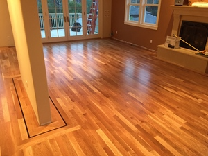 A newly installed hardwood floor in a spacious living room by Mattie's Hardwood Flooring in Petaluma, featuring natural wood tones and a smooth finish.