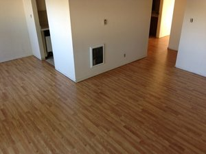 A room featuring newly installed hardwood flooring with light brown finish, showcasing the craftsmanship of Mattie's Hardwood Flooring in Petaluma.