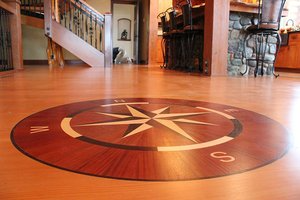 Intricately designed hardwood floor featuring a compass rose pattern, installed by Mattie's Hardwood Flooring in Petaluma.