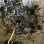 A damaged and corroded electrical outlet with exposed wires, indicating the need for repair, indicative of the quality work provided by Max Electric LLC in San Rafael.