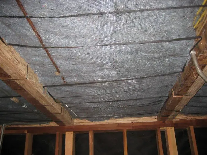 An interior view of a building ceiling showcasing environmentally friendly insulation installed by McHale's Environmental Insulation, Inc. in Concord.