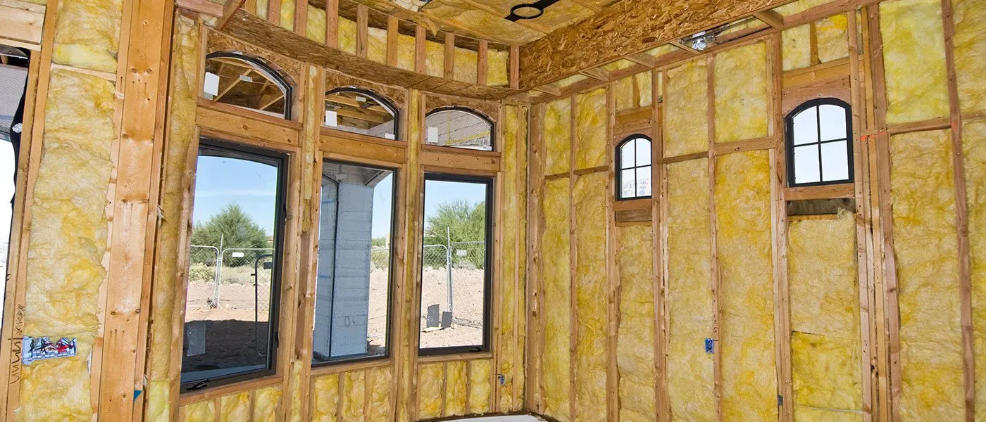 Image of a room under construction, featuring walls lined with yellow insulation materials by McHale's Environmental Insulation, Inc. in Concord.