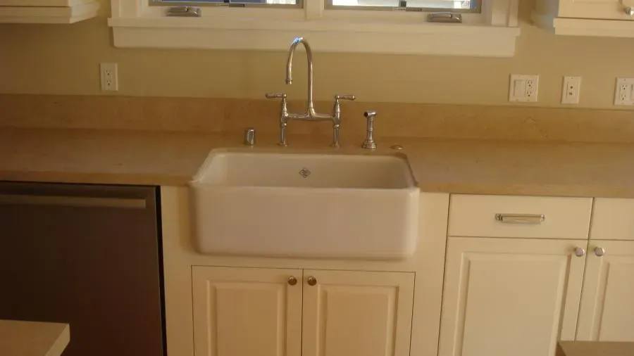 Kitchen sink installation in a countertop, featuring a modern stainless steel faucet setup, completed by Mike Testa Plumbing, Inc. in San Rafael.