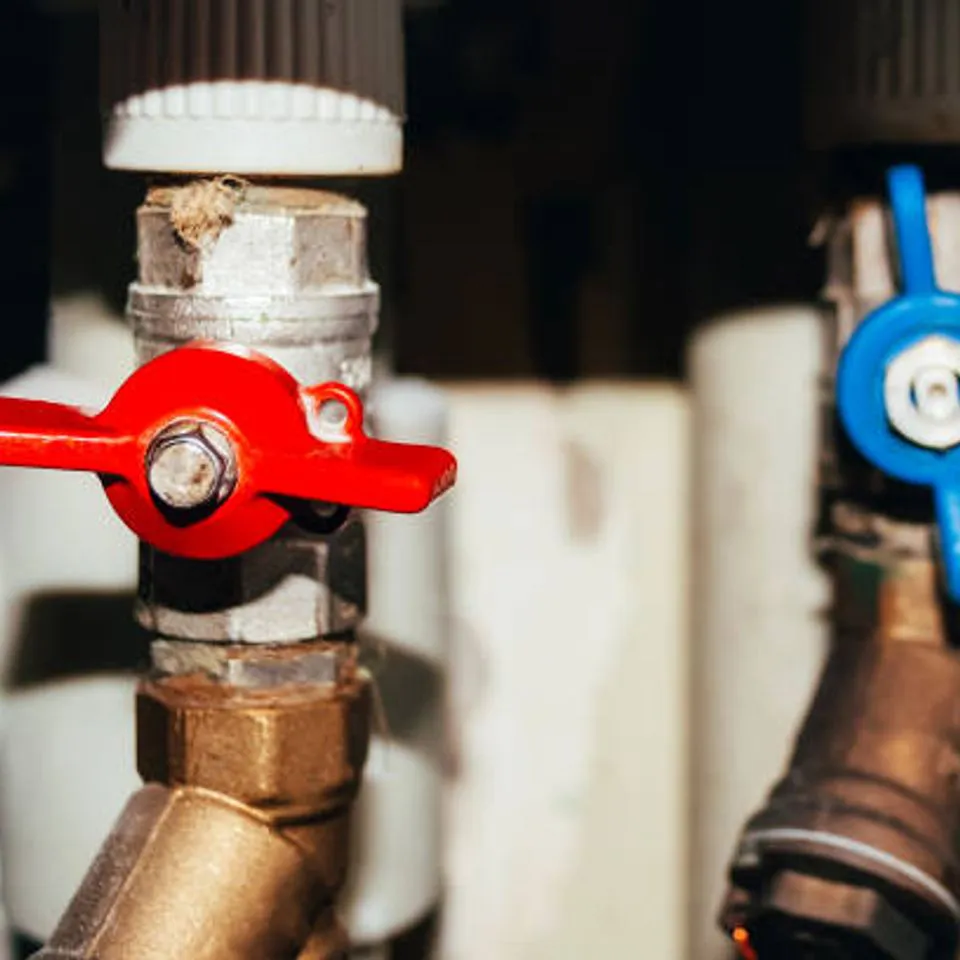 Close-up image of plumbing valves, one red and one blue, representing meticulous craftsmanship by Mike Testa Plumbing, Inc. in San Rafael.