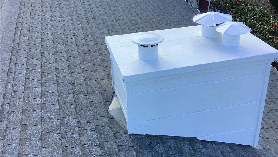 "A rooftop with gray shingles featuring a white vent enclosure installed by Mr. Roofing, Inc. in South San Francisco."