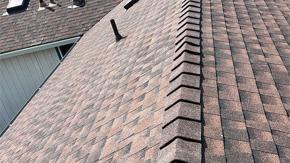 Close-up view of a shingled roof with a ridge, installed by Mr. Roofing, Inc. in South San Francisco.