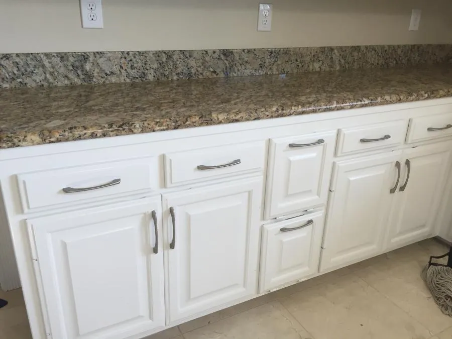 Image of a kitchen countertop with granite surface and white cabinets, showcasing a renovation by NBE Property Restoration in Santa Rosa.