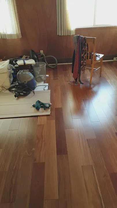 A room showcasing newly installed hardwood flooring, with sunlight streaming in, highlighting the craftsmanship of Navarro Flooring in Rohnert Park.