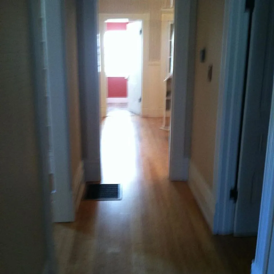 A hallway with newly installed hardwood flooring by Navarro Flooring, located in Rohnert Park.